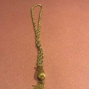 Bold goldtone over the head necklace had a very interesting pendant